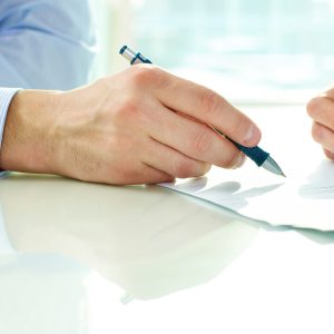 Two business partners signing a document